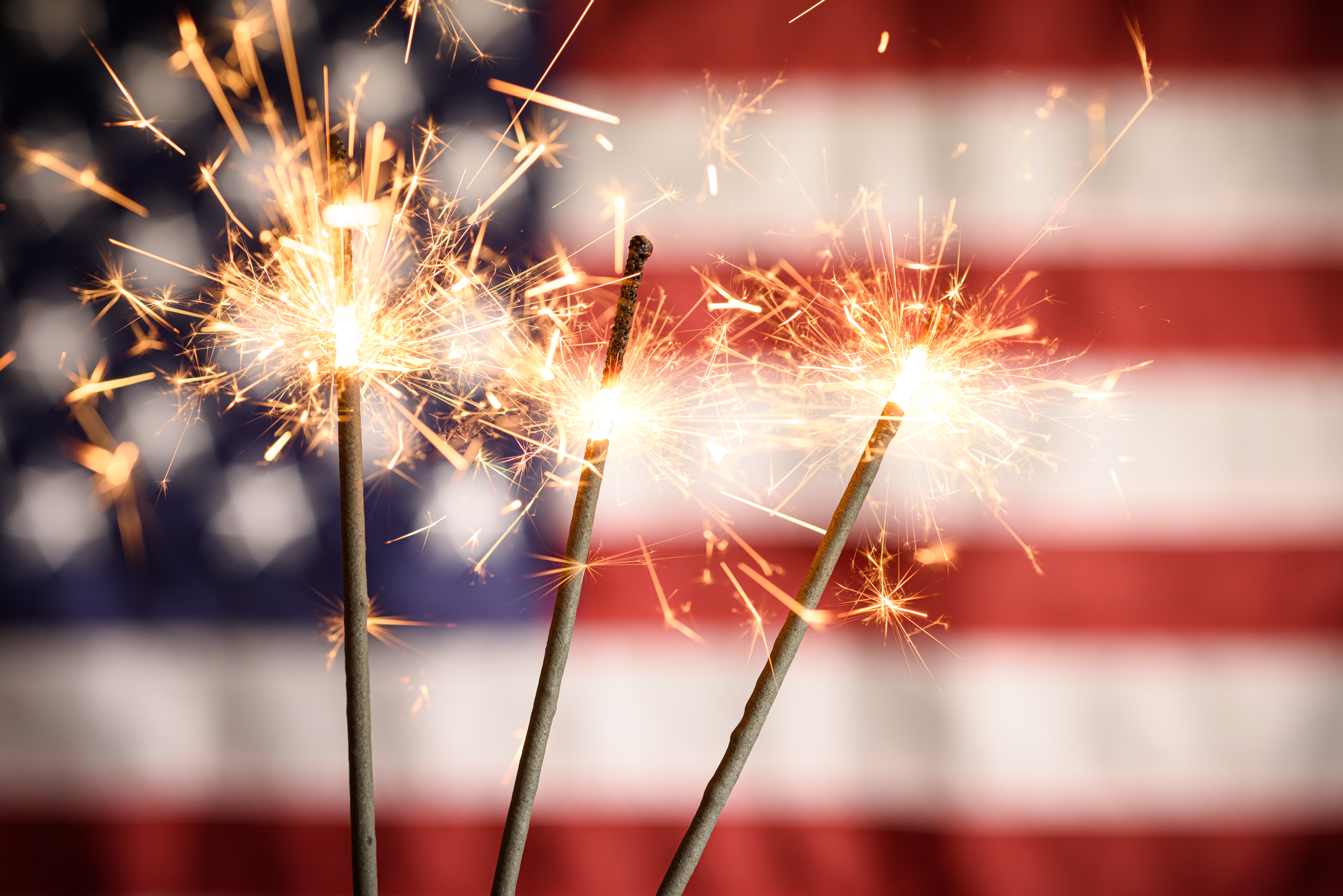 sparkler-closeup-with-american-flag-in-background